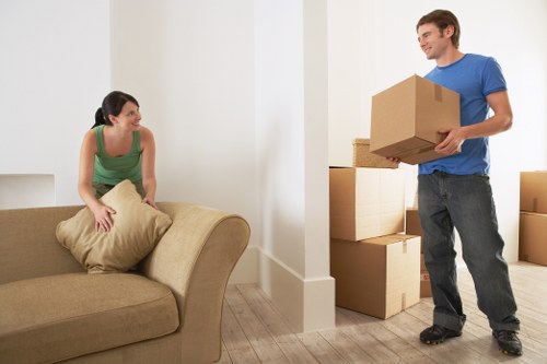 Professional movers carrying items through a Maida Vale apartment building